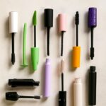 Vegan mascara wand beside drugstore mascara tubes