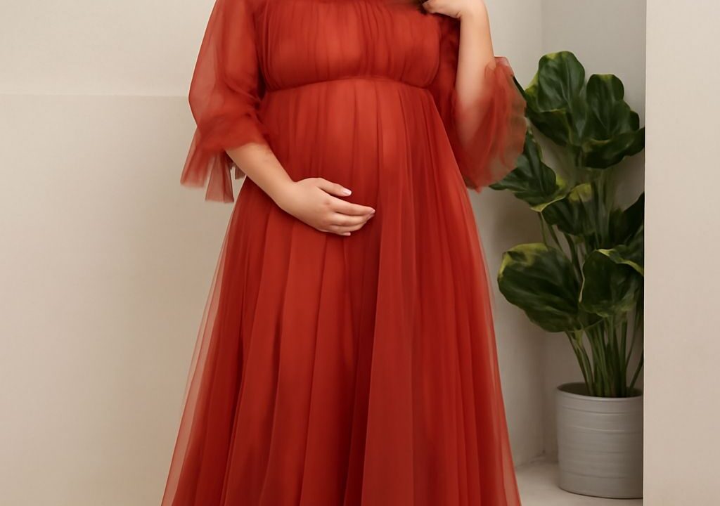 Expecting mother wearing a stylish maternity dress at a baby shower