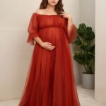 Expecting mother wearing a stylish maternity dress at a baby shower