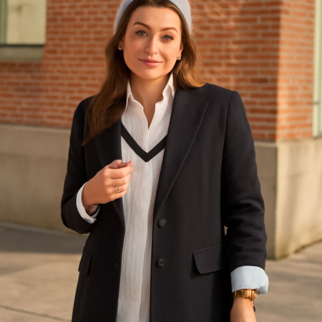 A stylish woman wearing a navy blazer.